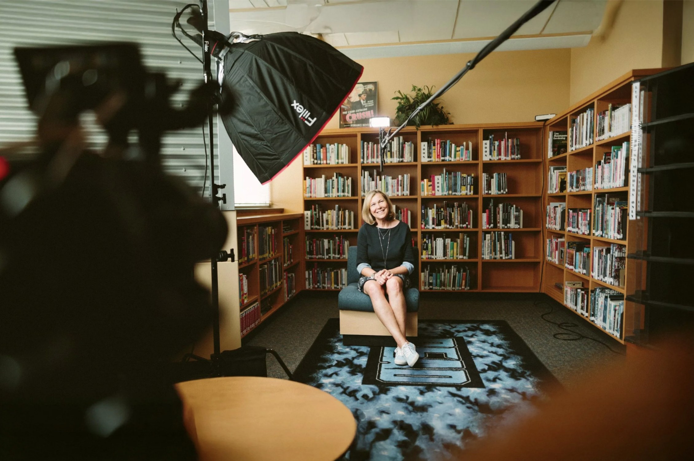 Corporate interview video production - subject being filmed on set with softbox lighting