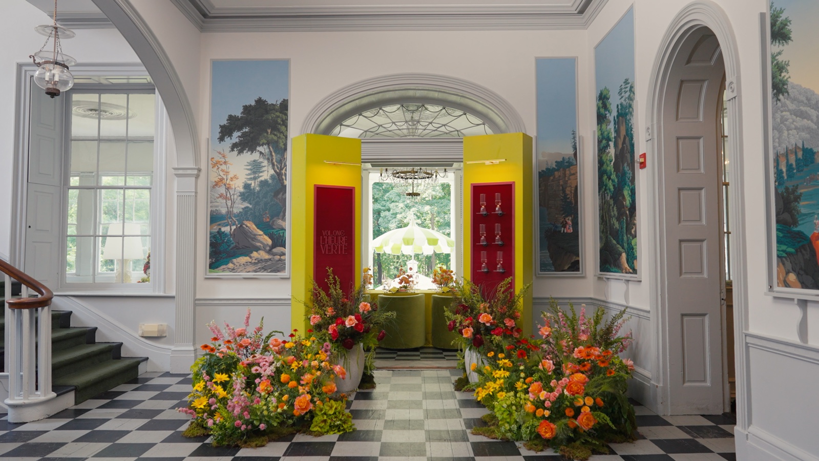 The completed Experience Chartreuse floral and tablescape installation viewed through the mansion doorway